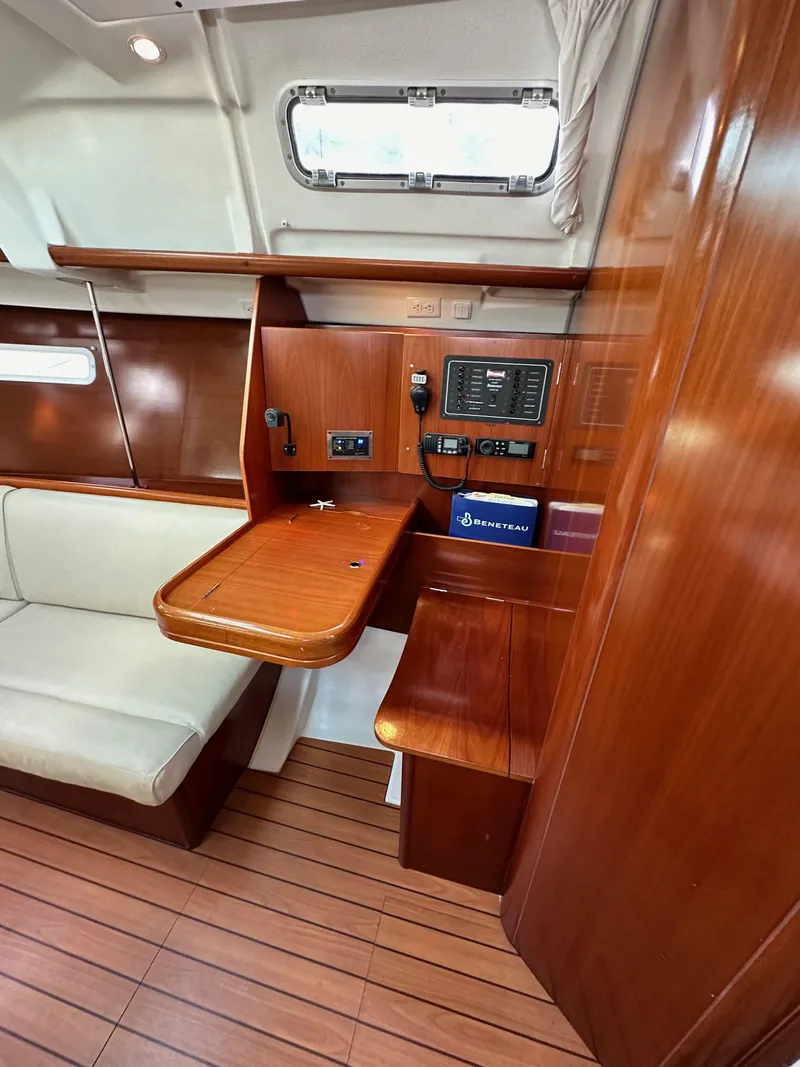 Slide: The Image of 2005 Beneteau 373 yacht interior with wooden finish and navigation station. - 41