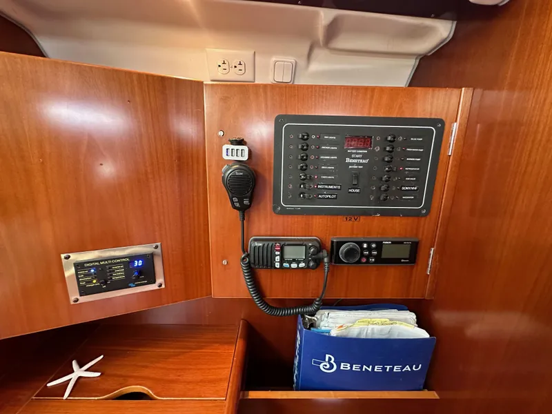 Slide: The Image of Control panel of a 2005 Beneteau 373 sailboat with communication equipment and storage. - 42