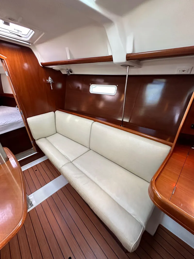 Slide: The Image of Interior of 2005 Beneteau 373 sailboat with white sofa and wooden accents. - 45