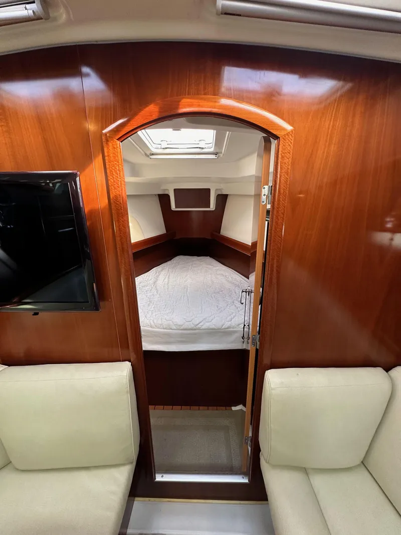 Slide: The Image of Interior of 2005 Beneteau 373 sailboat with cozy cabin and wooden finish. - 46