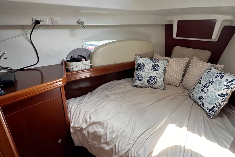 Slide: The Image of Cozy cabin interior of 2005 Beneteau 373 sailboat with decorative pillows and wooden cabinetry. - 49