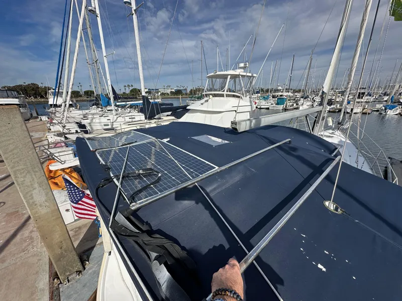 Slide: The Image of 2005 Beneteau 373 sailboat docked at marina with solar panels on deck. - 7