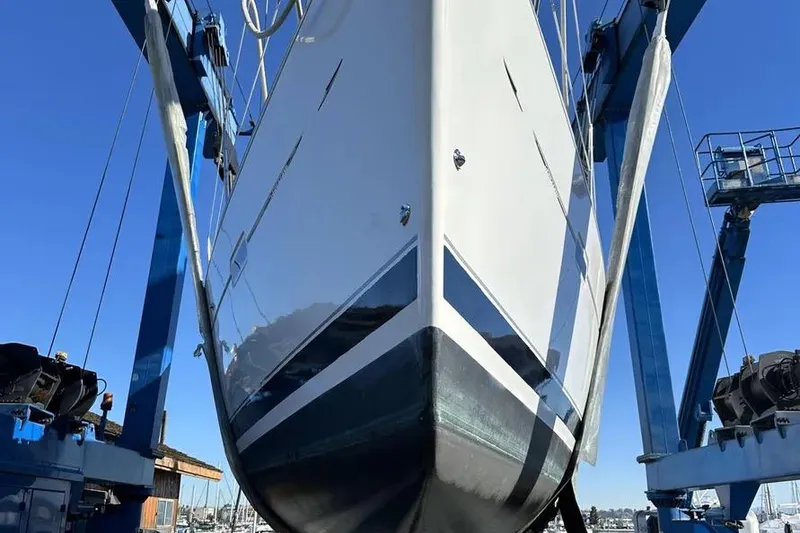 Slide: The Image of 2005 Beneteau 373 sailboat in dry dock, viewed from below, with blue sky background. - 71