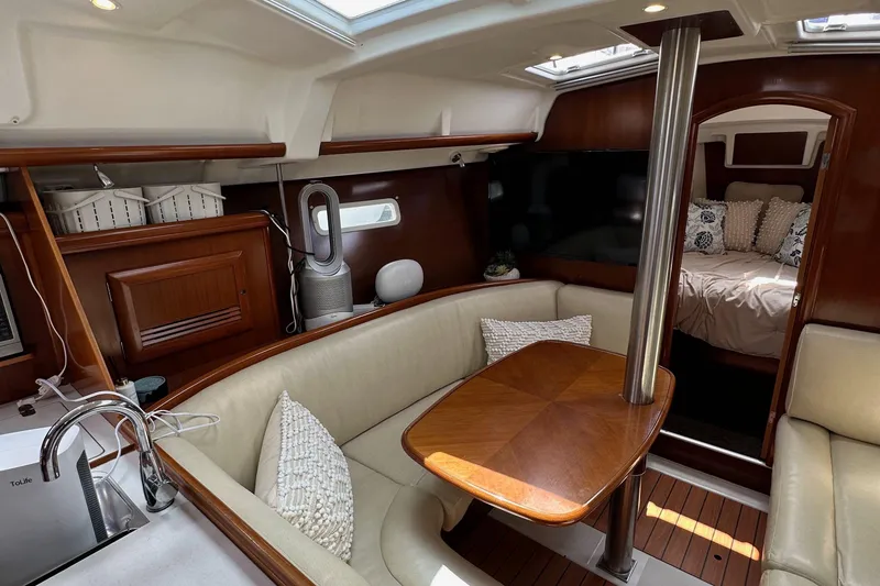 Slide: The Image of Luxurious interior of a 2005 Beneteau 373 sailboat with cozy seating and elegant wood finishes. - 74