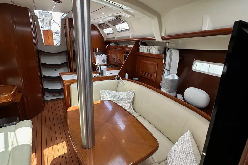 Slide: The Image of Interior of 2005 Beneteau 373 sailboat with wood finish and cozy seating area. - 77