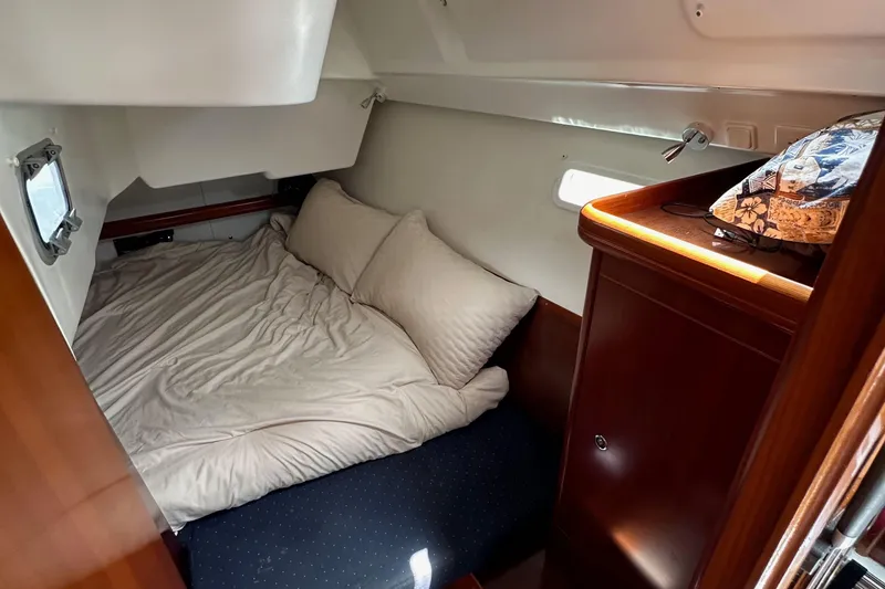 Slide: The Image of Cozy cabin interior of 2005 Beneteau 373 sailboat with bed and wooden cabinetry. - 79