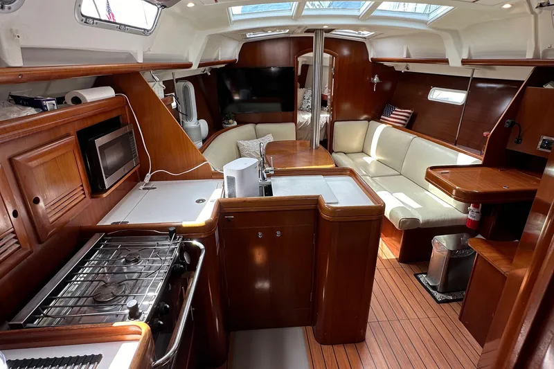Slide: The Image of Luxurious interior of a 2005 Beneteau 373 sailboat with wood finishes and modern amenities. - 81