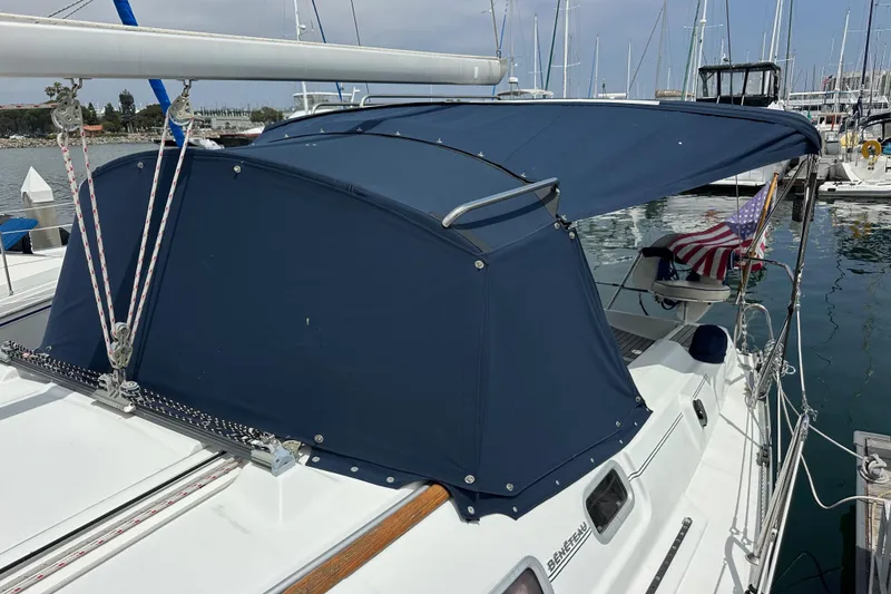 Slide: The Image of 2005 Beneteau 373 sailboat with blue canopy docked in marina. - 85