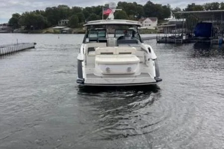 Slide: The Image of 2019 Cobalt A40 boat on a lake, rear view with American flag. - 11