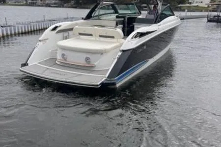 Slide: The Image of 2019 Cobalt A40 boat on water, rear view showcasing sleek design and spacious seating. - 12