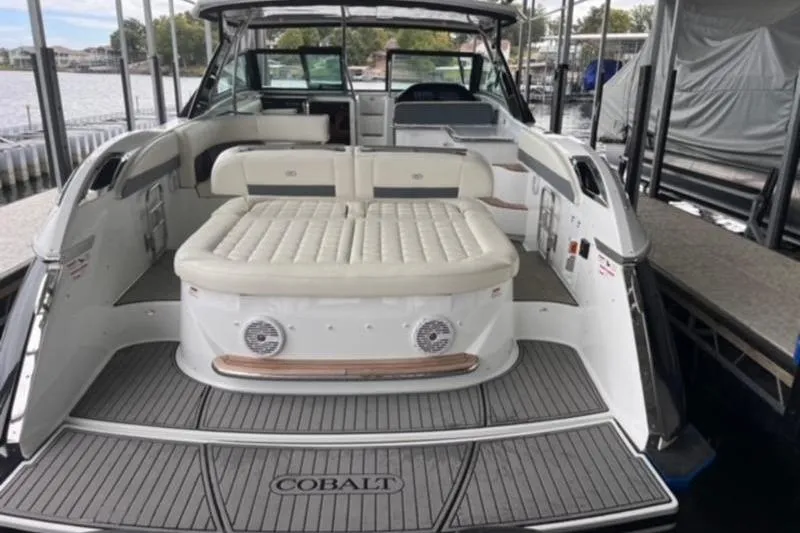 Slide: The Image of 2019 Cobalt A40 boat with spacious seating and elegant design at a dock. - 2