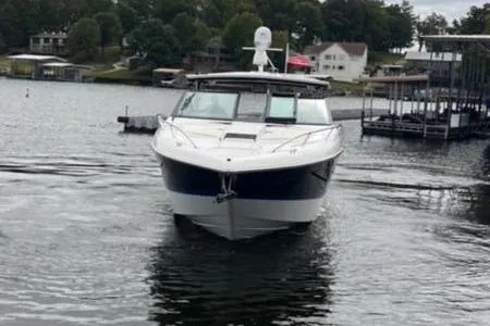 Slide: The Image of 2019 Cobalt A40 boat on a lake, surrounded by docks and trees. - 5