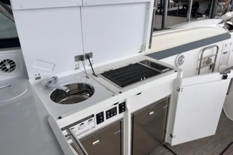 Slide: The Image of 2019 Cobalt A40 yacht kitchenette with sink, grill, and storage cabinets. - 6