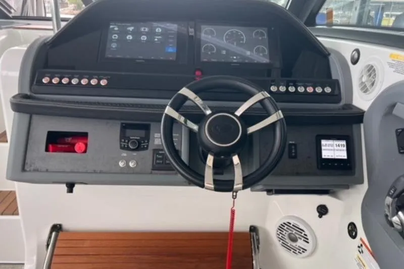 Slide: The Image of 2019 Cobalt A40 boat dashboard with steering wheel and digital controls. - 9