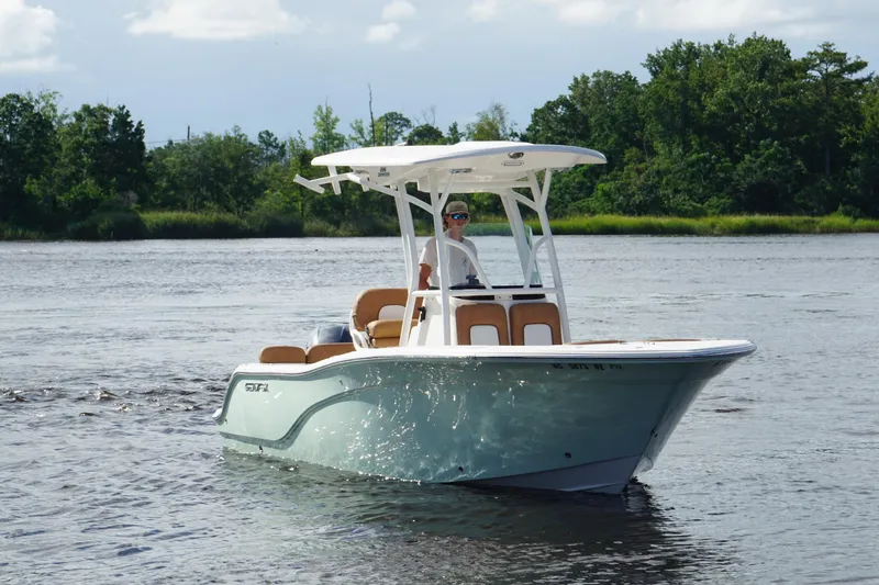 Slide: The Image of 2018 Sea Fox 226 Commander boat cruising on a calm river with lush green trees. - 12
