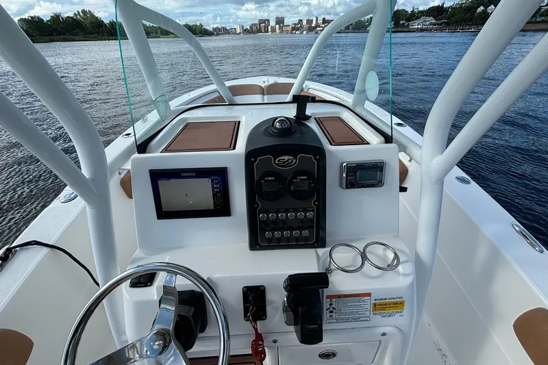 Slide: The Image of 2018 Sea Fox 226 Commander boat dashboard with steering wheel and navigation controls. - 14