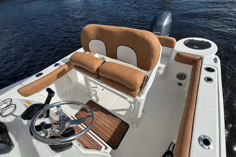 Slide: The Image of 2018 Sea Fox 226 Commander boat interior with tan seating and steering wheel. - 15