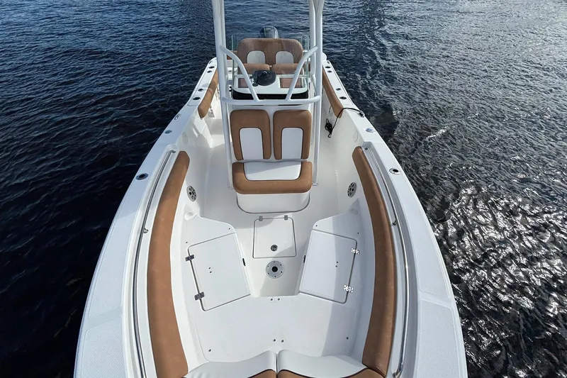Slide: The Image of 2018 Sea Fox 226 Commander boat with tan seating on calm water. - 16