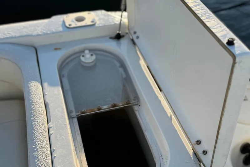 Slide: The Image of Open storage compartment on a 2003 Triton 2690 CC boat, showing interior details. - 11