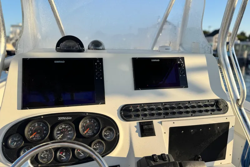 Slide: The Image of Dashboard of a 2003 Triton 2690 CC boat with Simrad displays and gauges. - 6