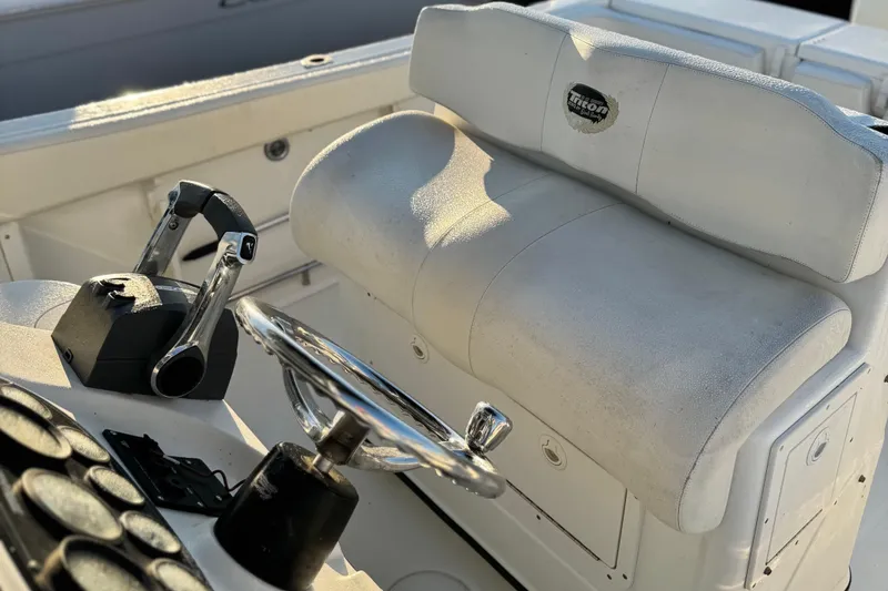 Slide: The Image of 2003 Triton 2690 CC boat interior with steering wheel and control panel. - 8