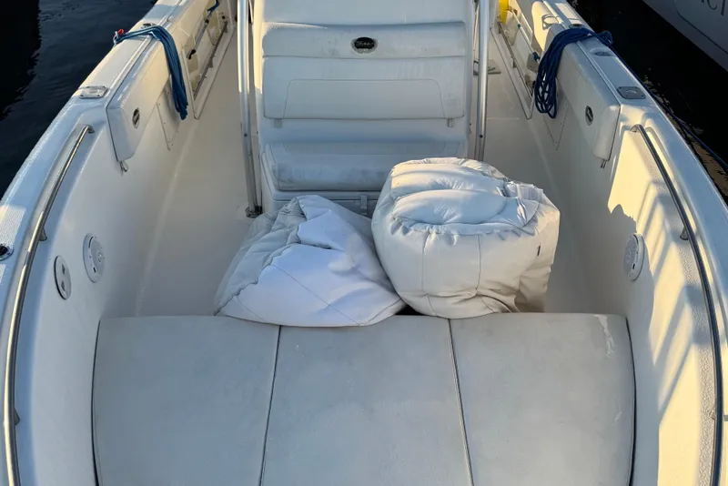 Slide: The Image of 2003 Triton 2690 CC boat interior with cushions and ropes on deck. - 9