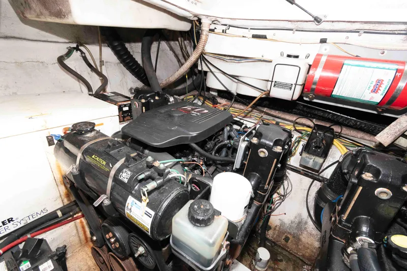Slide: The Image of Engine room of a 2006 Maxum 3300 SE boat, featuring mechanical components and wiring. - 10