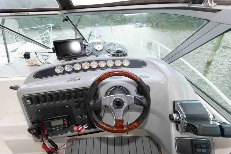 Slide: The Image of 2006 Maxum 3300 SE boat helm with steering wheel and navigation instruments. - 3