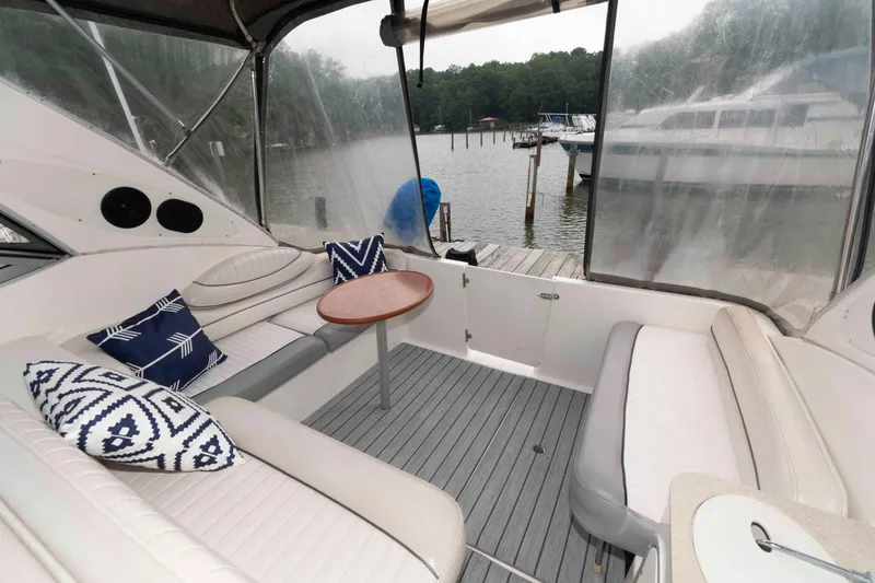 Slide: The Image of 2006 Maxum 3300 SE yacht interior with seating, table, and decorative pillows. - 5