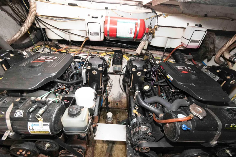 Slide: The Image of Engine room of a 2006 Maxum 3300 SE boat with dual engines and fire extinguisher. - 8