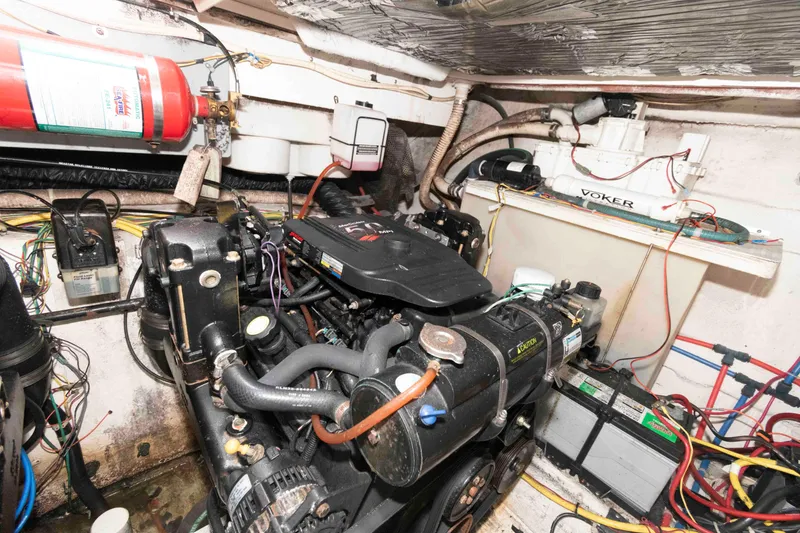 Slide: The Image of Engine room of a 2006 Maxum 3300 SE boat, featuring mechanical components and wiring. - 9