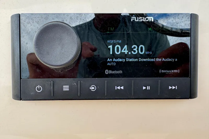 Slide: The Image of Fusion marine stereo display on 2023 Scout 215 Dorado boat, showing FM 104.30 MHz. - 19