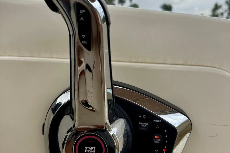 Slide: The Image of Close-up of 2023 Scout 215 Dorado boat throttle control with start engine button. - 20