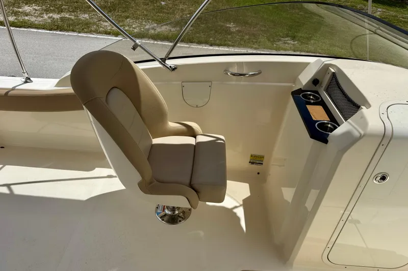 Slide: The Image of 2023 Scout 215 Dorado boat interior with beige captain's chair and console. - 21