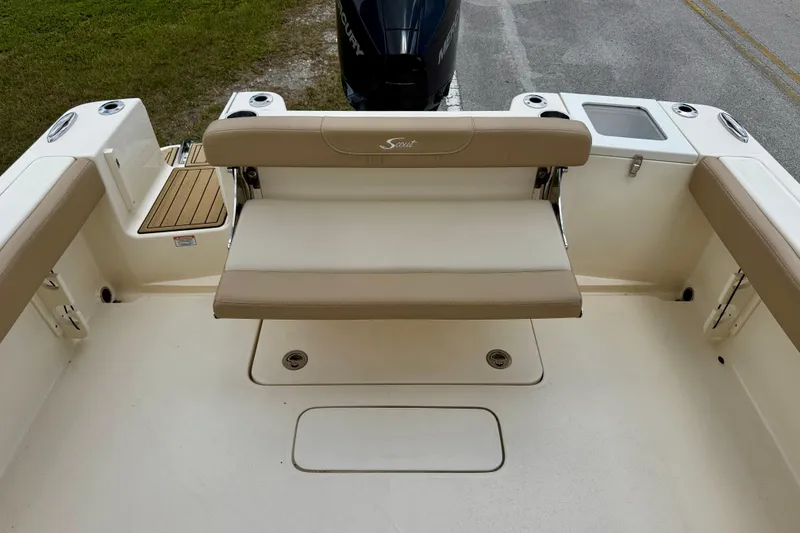 Slide: The Image of 2023 Scout 215 Dorado boat interior with beige seating and storage compartments. - 22