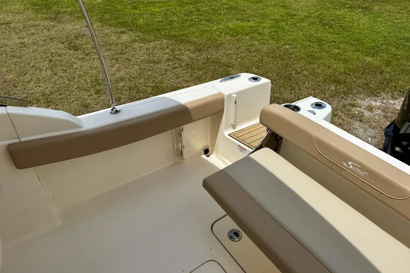 Slide: The Image of 2023 Scout 215 Dorado boat interior with tan seating and cup holders. - 23