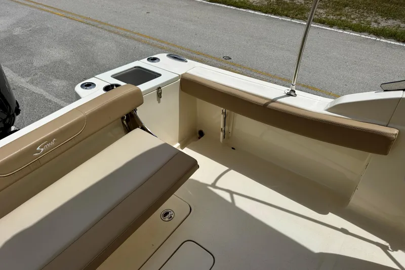 Slide: The Image of 2023 Scout 215 Dorado boat interior with beige seating and storage compartments. - 24