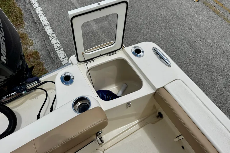 Slide: The Image of 2023 Scout 215 Dorado boat interior with open storage compartment and seating. - 25