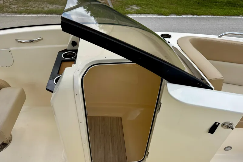 Slide: The Image of 2023 Scout 215 Dorado boat interior with open storage compartment and seating area. - 27