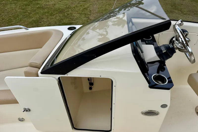 Slide: The Image of 2023 Scout 215 Dorado boat interior with steering wheel and seating area. - 28