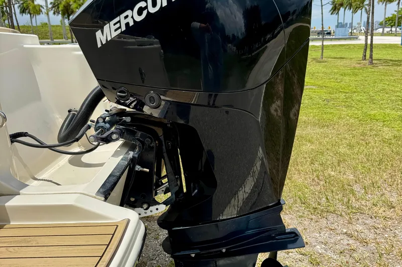 Slide: The Image of 2023 Scout 215 Dorado with Mercury outboard engine, parked on grass. - 32