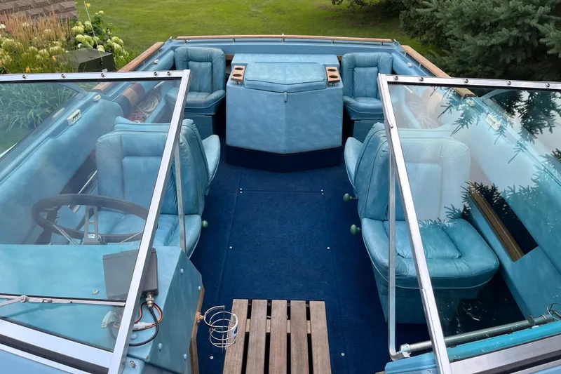 Slide: The Image of 1983 Century 3000 Bowrider interior with blue seating and wooden accents. - 10