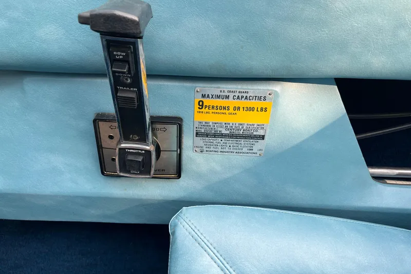 Slide: The Image of Throttle control and capacity label on 1983 Century 3000 Bowrider boat dashboard. - 14