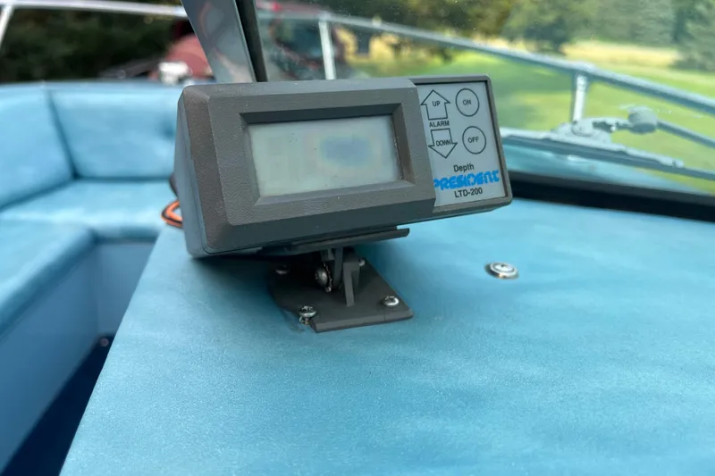 Slide: The Image of Depth finder on 1983 Century 3000 Bowrider boat dashboard with blue upholstery. - 15
