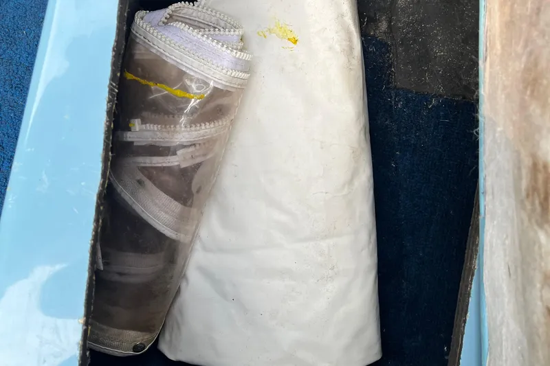 Slide: The Image of Stored boat cover and clear plastic in 1983 Century 3000 Bowrider compartment. - 26