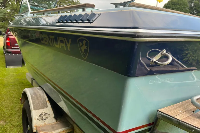 Slide: The Image of 1983 Century 3000 Bowrider boat on trailer, side view with logo visible. - 5