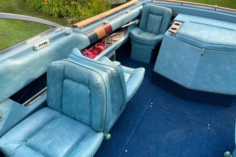Slide: The Image of 1983 Century 3000 Bowrider interior with blue seats and carpet, showcasing vintage design. - 8