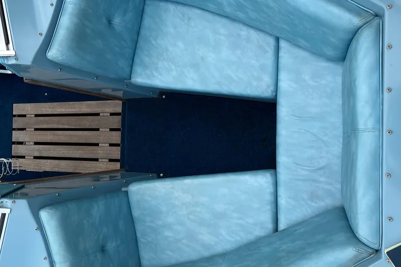 Slide: The Image of Interior of 1983 Century 3000 Bowrider with blue seating and wooden flooring. - 11