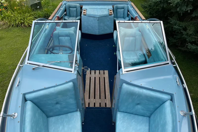 Slide: The Image of 1983 Century 3000 Bowrider with blue interior, open seating, and wooden flooring. - 12
