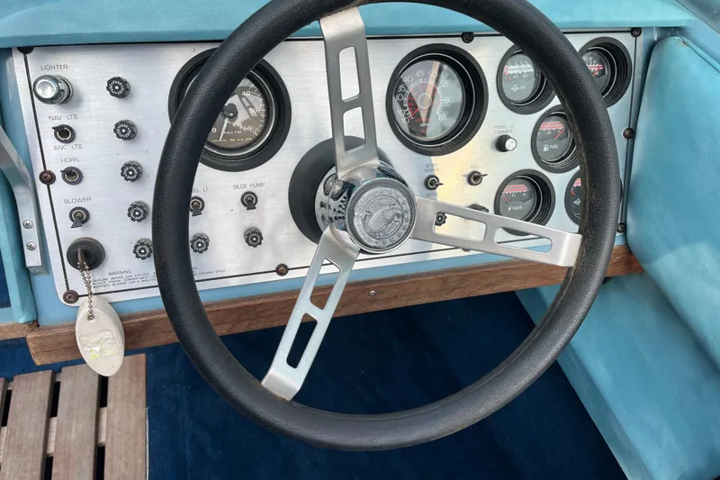 Slide: The Image of Dashboard of a 1983 Century 3000 Bowrider boat with steering wheel and gauges. - 13